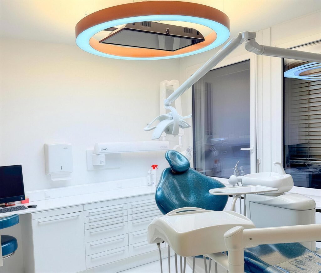 Treatment room with a modern chair and a ceiling screen